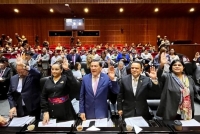 El grupo parlamentario de Morena emite su voto durante de la sesión de a Comisión de Puntos Constitucionales de la Cámara de Diputados.