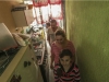 Debido a lo estrecho del espacio, la familia Gutiérrez cruza uno a uno por su cocina