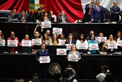 Los legisladores de Morena suben a tribuna con pancartas en apoyo a la Ley de Amparo, durante la sesión en la Cámara de Diputados, en la Ciudad de México, el 14 de octubre de 2025.
